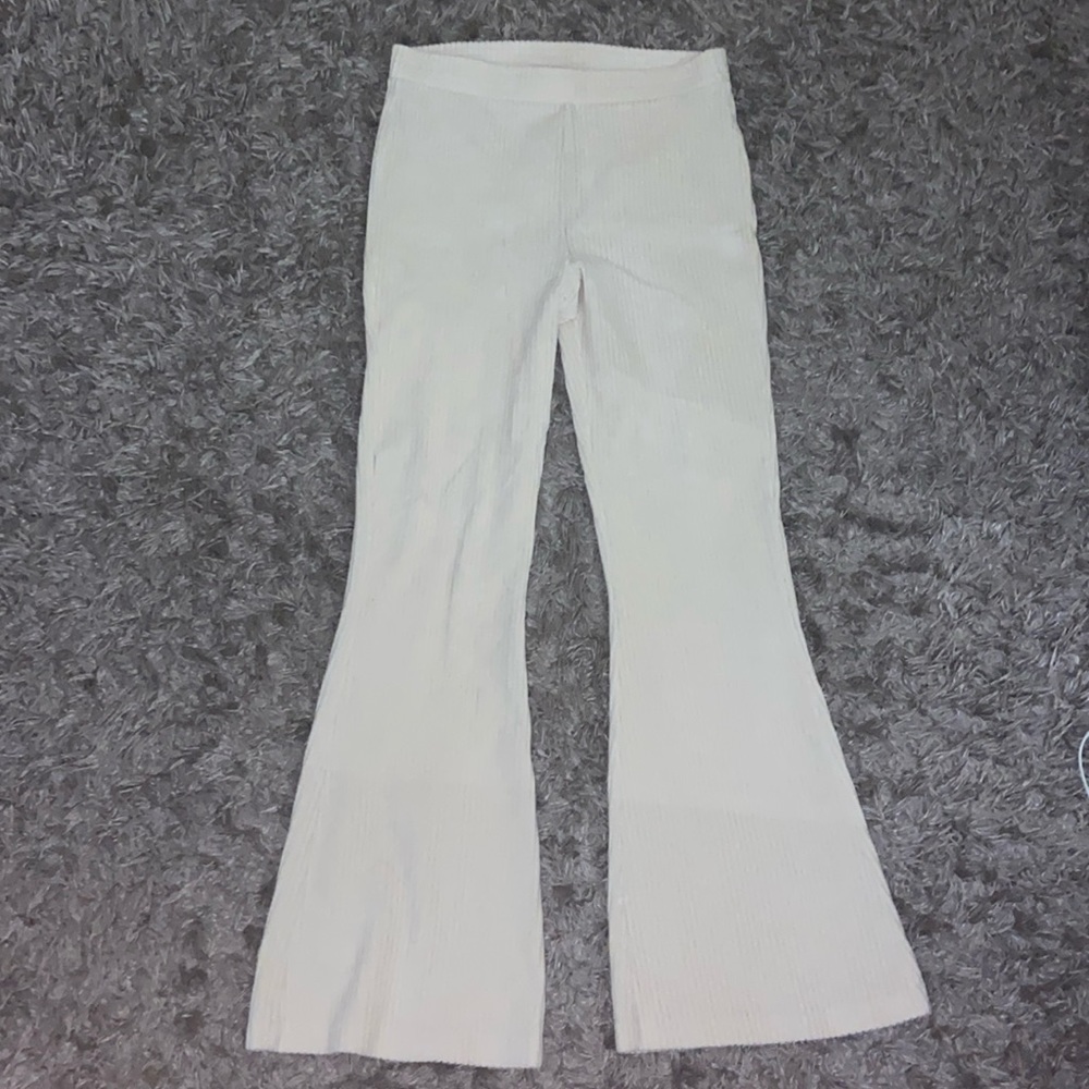 It’s crème white Aries bell bottom cotton with stripped texture
